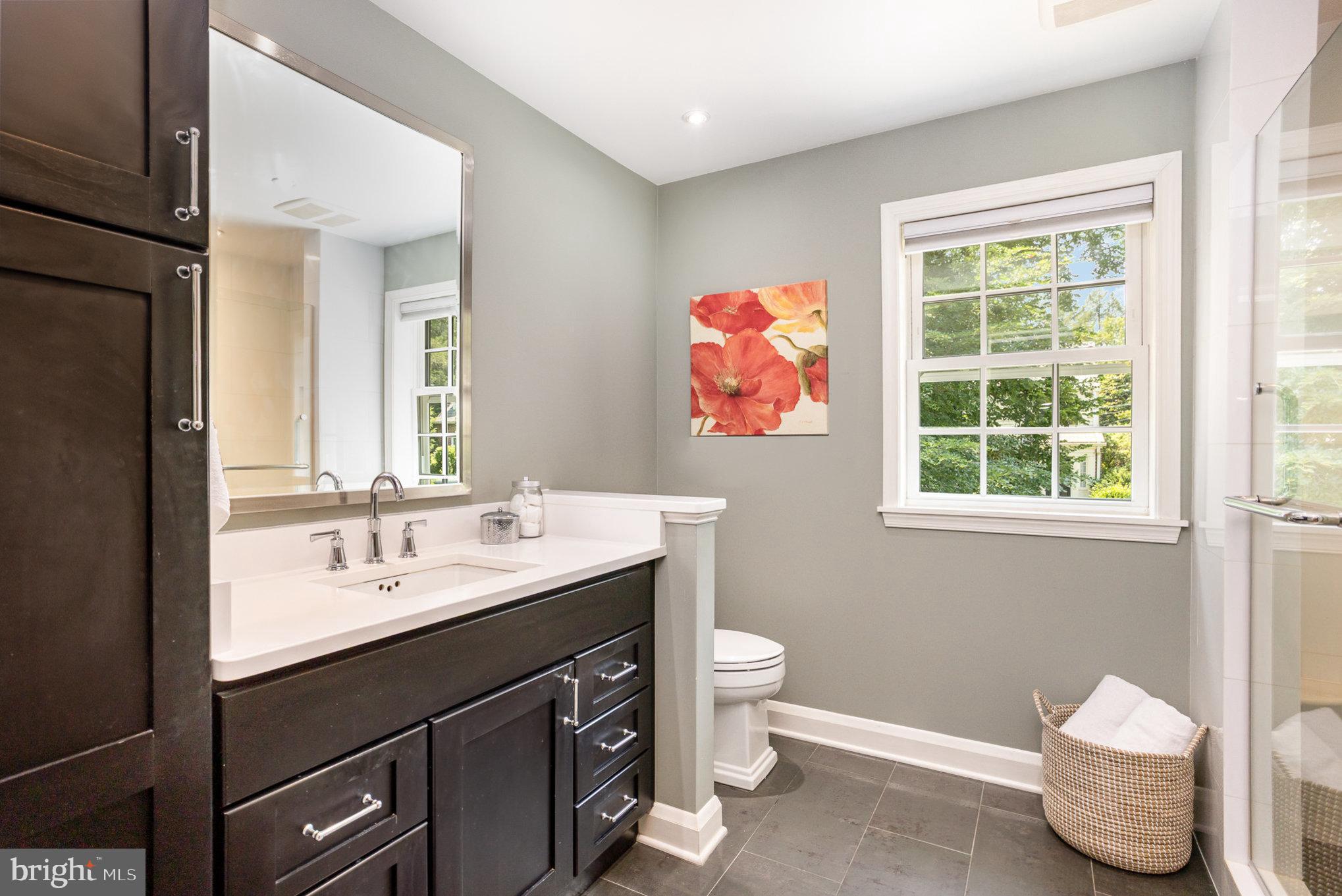 4407 Sedgwick Road Baltimore, MD 21210 - Photo 26 of 42 a bathroom with a sink toilet and a mirror