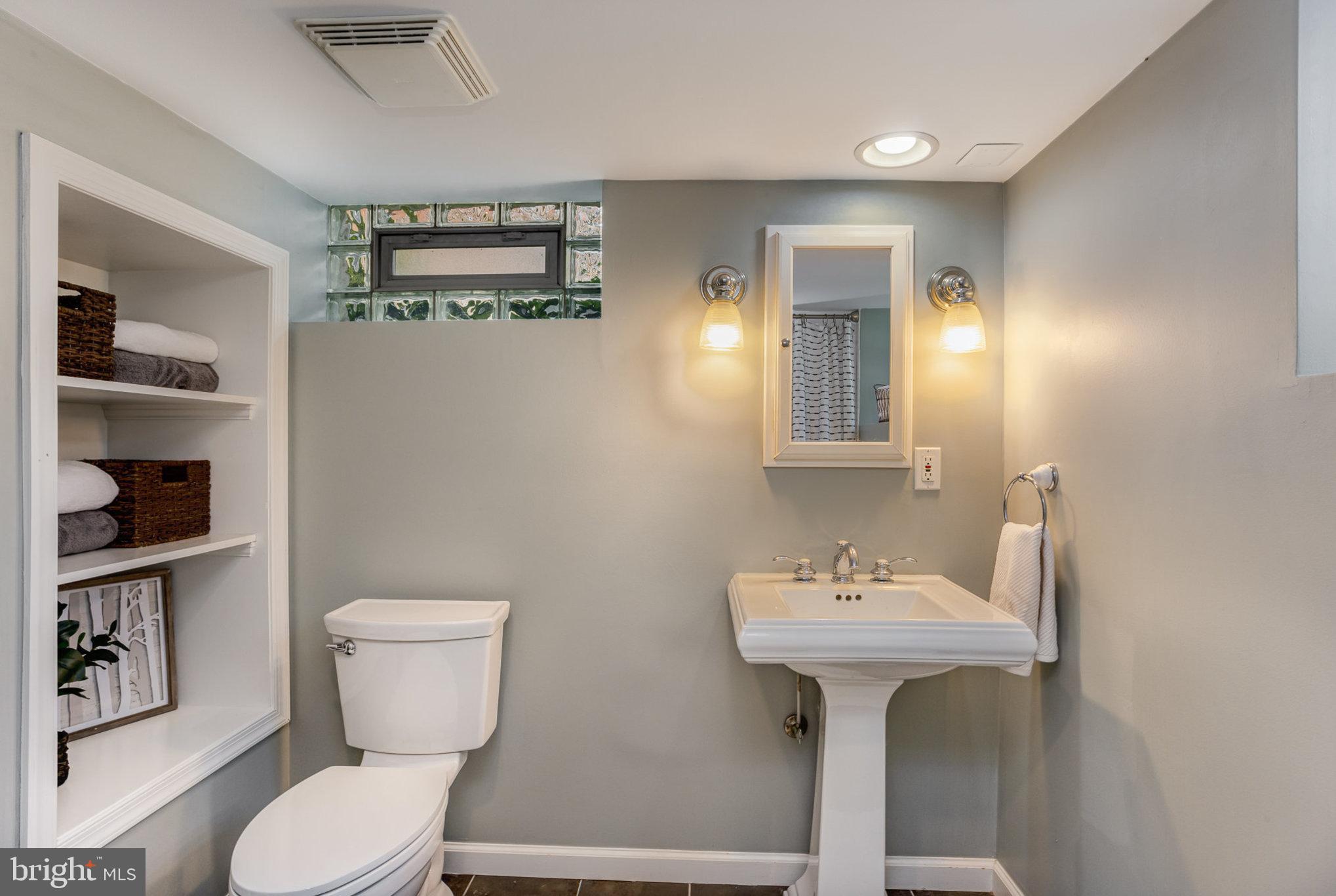 4407 Sedgwick Road Baltimore, MD 21210 - Photo 32 of 42 a bathroom with a toilet sink and mirror