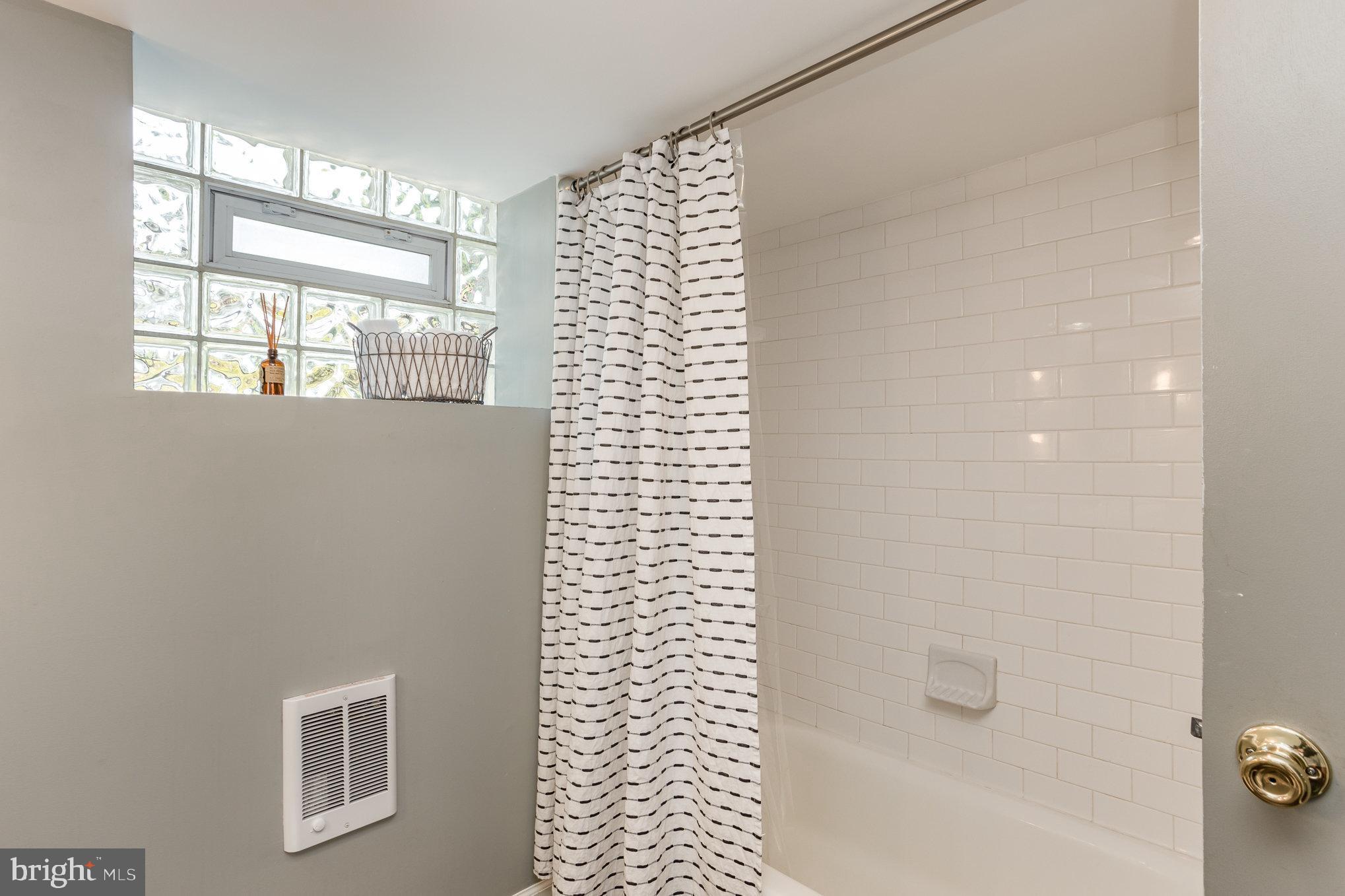 4407 Sedgwick Road Baltimore, MD 21210 - Photo 33 of 42 a bathroom with a bathtub and shower