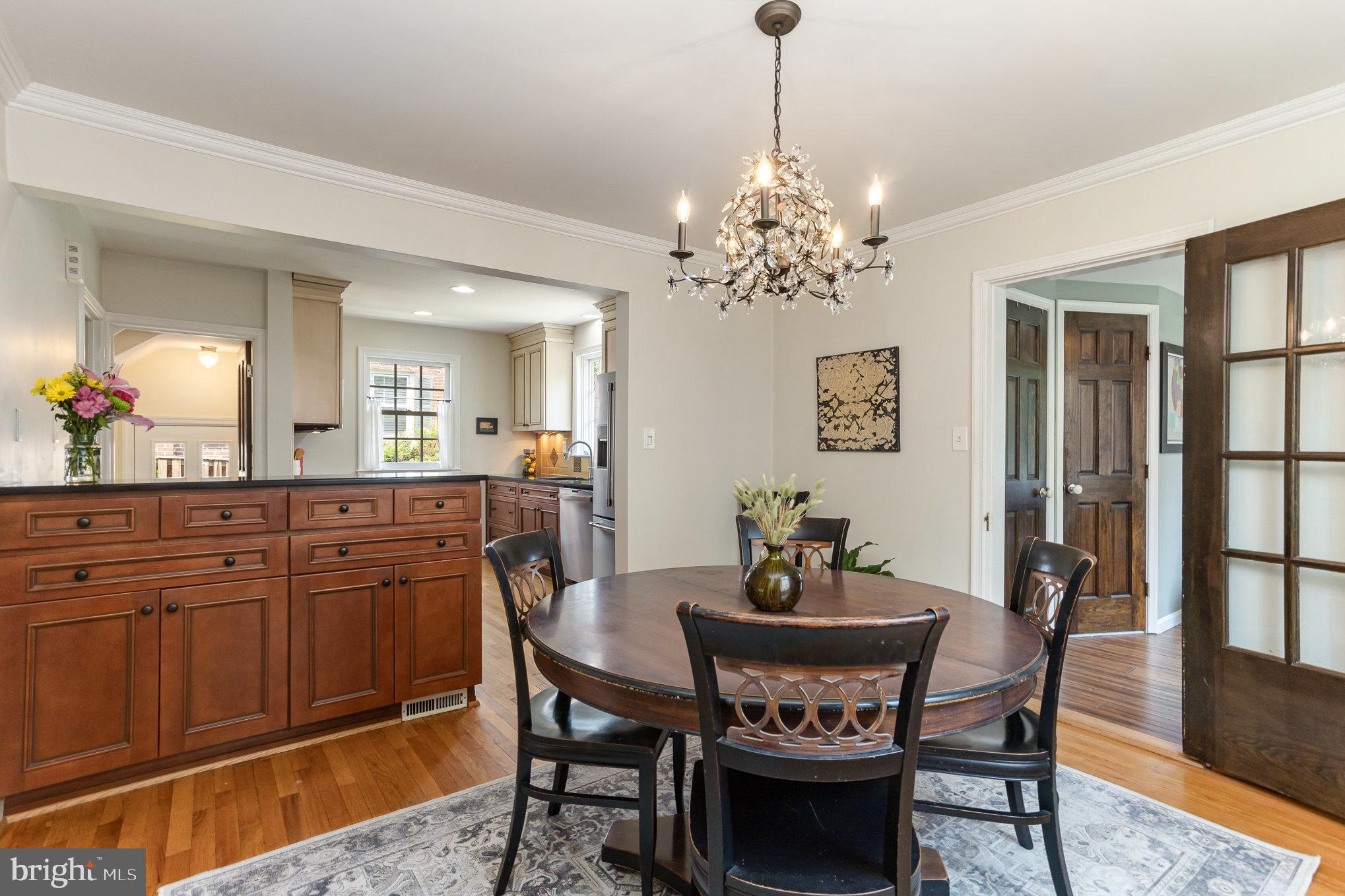 4407 Sedgwick Road Baltimore, MD 21210 - Photo 5 of 42 a dining room with furniture a chandelier and wooden floor