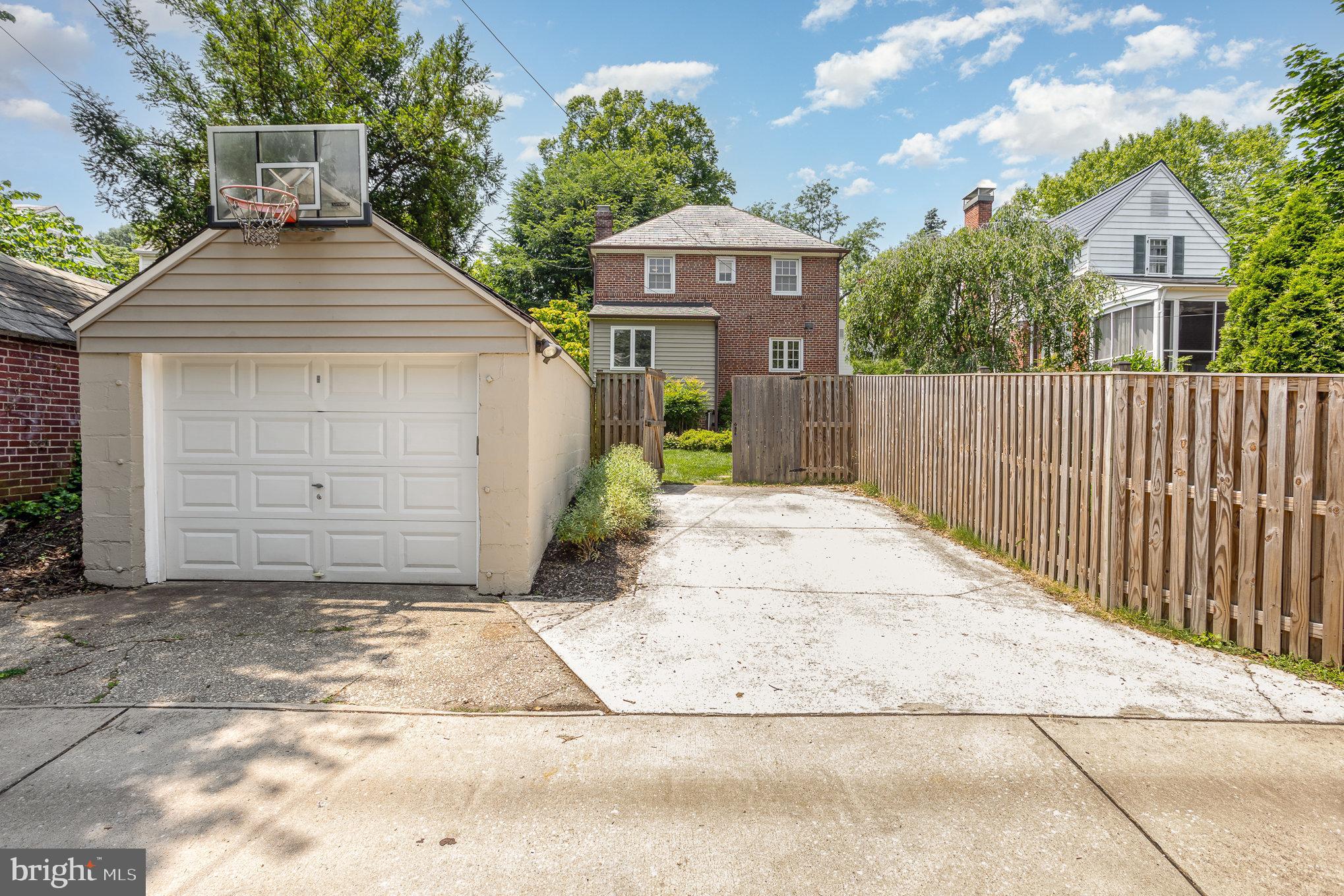 4407 Sedgwick Road Baltimore, MD 21210 - Photo 6 of 42 a view of a house with a small yard and wooden fence