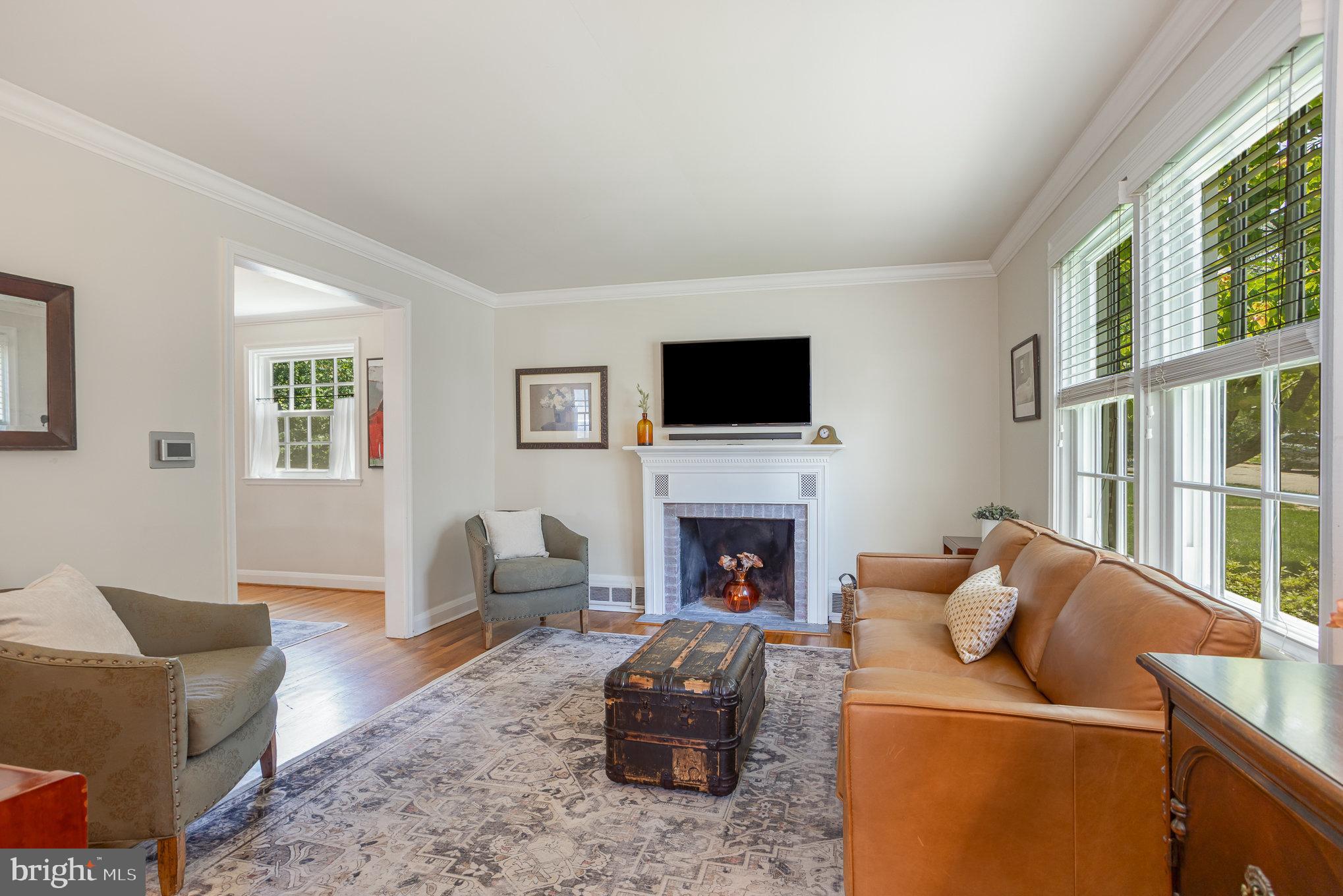 4407 Sedgwick Road Baltimore, MD 21210 - Photo 8 of 42 a living room with furniture a flat screen tv and a fireplace