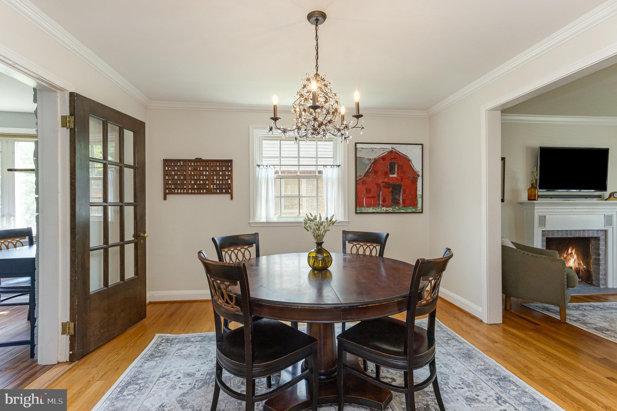 4407 Sedgwick Road Baltimore, MD 21210 - Photo 9 of 42 a view of a dining room with furniture wooden floor and a chandelier