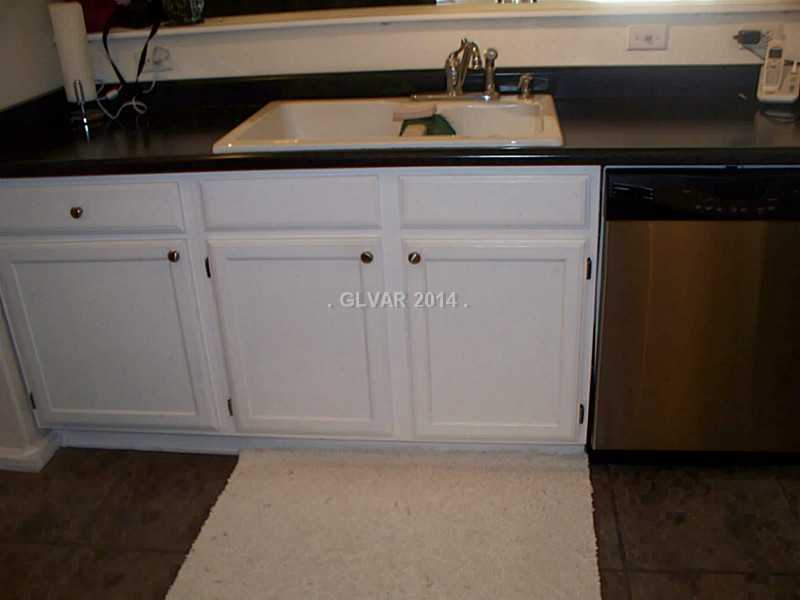 7255 West Sunset Road, Unit 2144 Las Vegas, NV 89113 - Photo 13 of 19 Kitchen. Sink area faces the breakfast bar and patio doors. Deep sink and check out the faucet