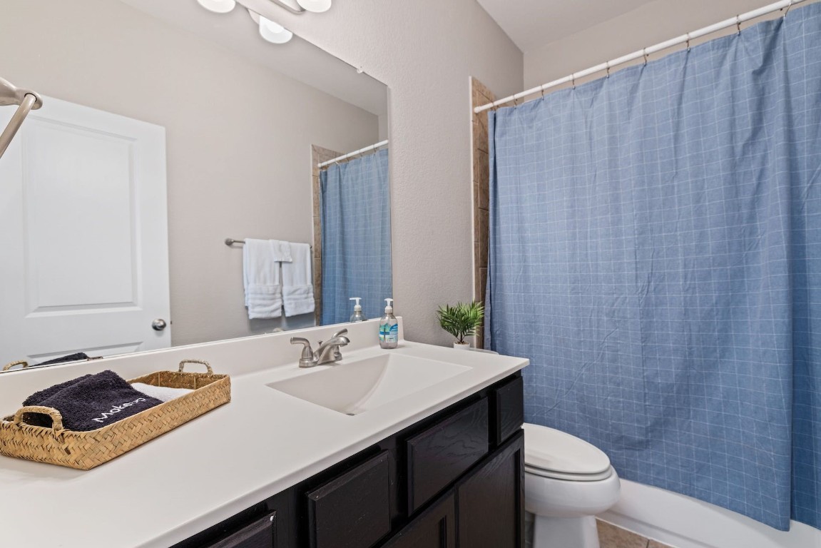 2215 Katy Lane, Unit C Georgetown, TX 78626 - Photo 18 of 26 a bathroom with a sink a toilet and shower