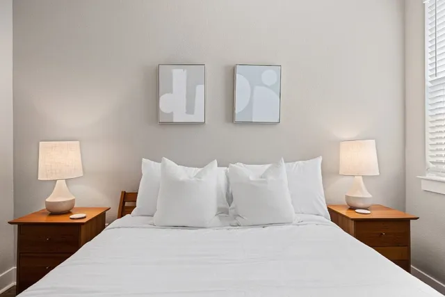 a bedroom with a bed and window