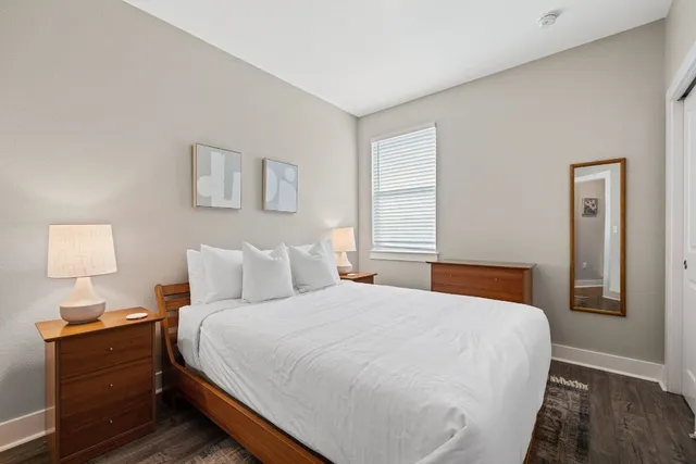 a bedroom with a bed and a lamp