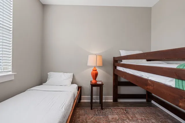 a bedroom with a bed and a lamp