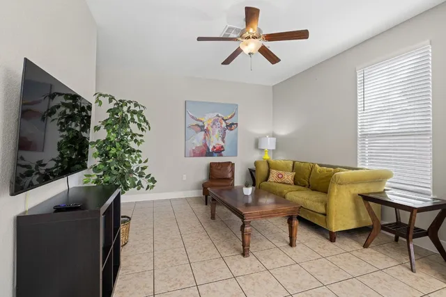 a living room with furniture and a potted plant