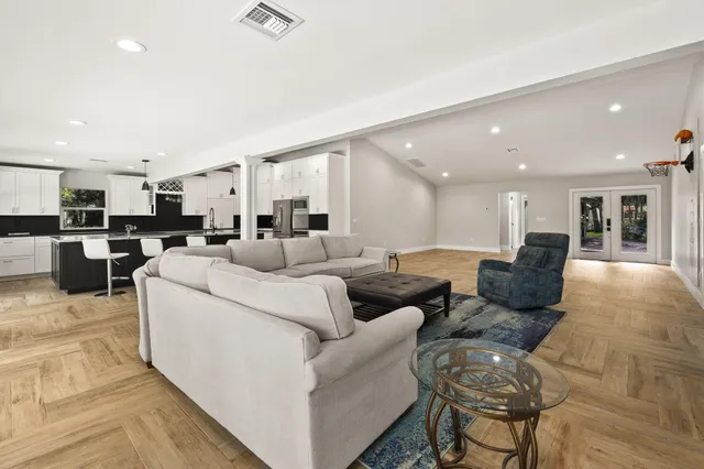 a kitchen with stainless steel appliances granite countertop a sink stove and cabinets