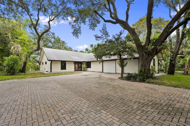 a large kitchen with a table and chairs