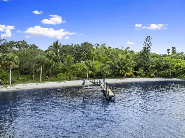 a kitchen with stainless steel appliances granite countertop a sink and a refrigerator