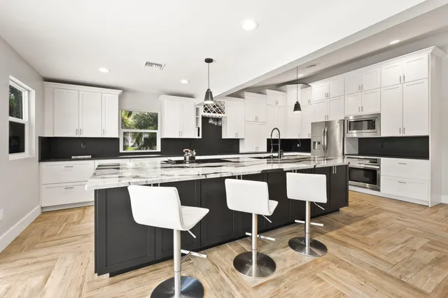 a spacious bedroom with a large bed and a large window