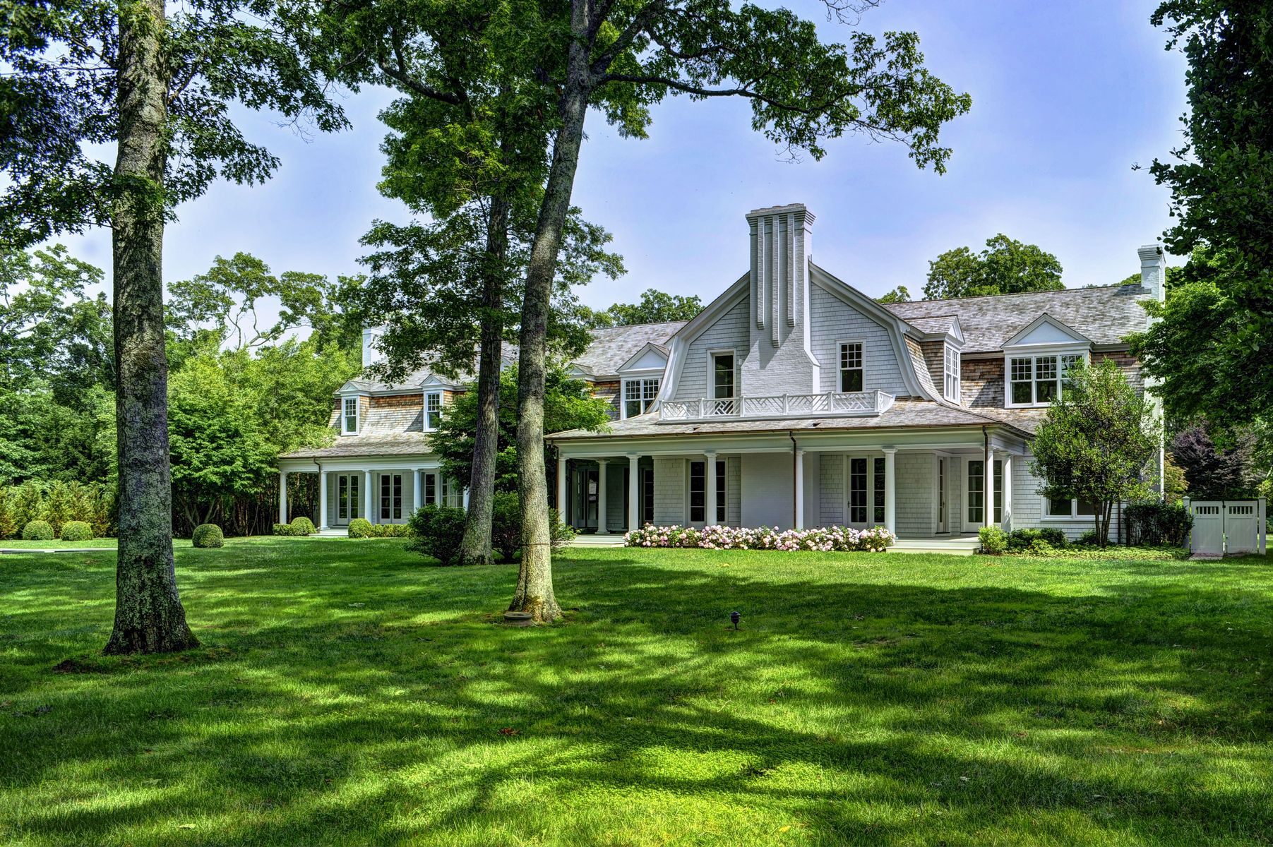 11 Jones Cove Road East Hampton, NY 11937 - Photo 2 of 25 a front view of a house with a garden