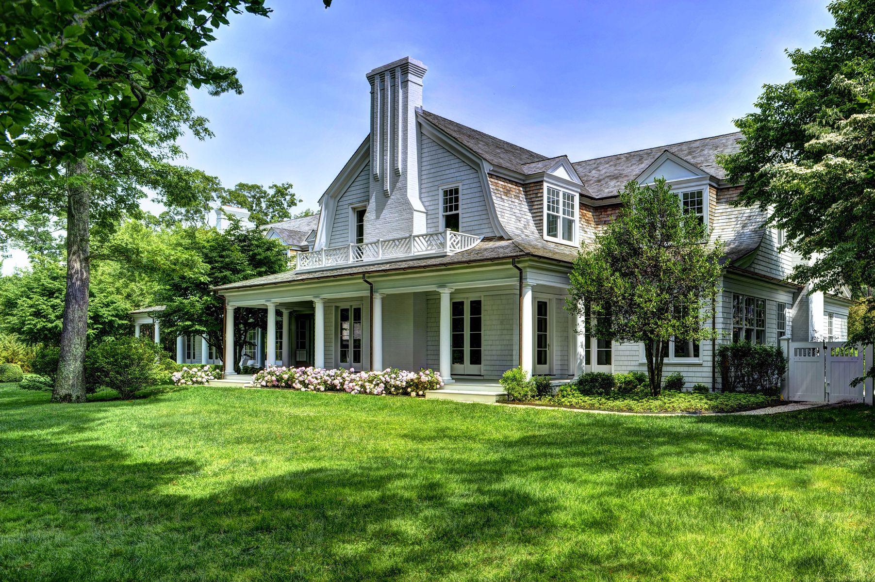 11 Jones Cove Road East Hampton, NY 11937 - Photo 3 of 25 a front view of a house with a yard table and chairs