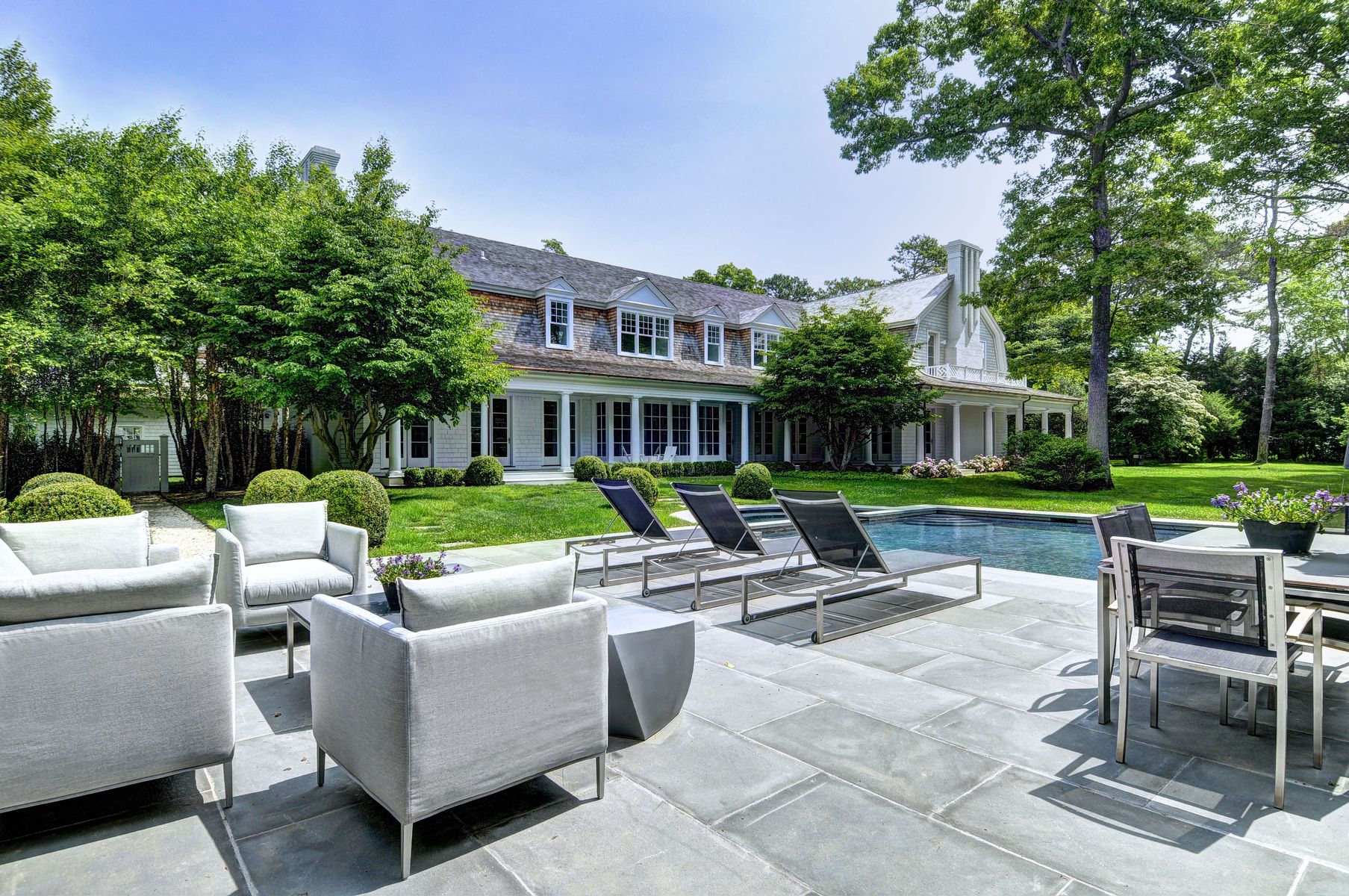 11 Jones Cove Road East Hampton, NY 11937 - Photo 4 of 25 a view of a patio with couches and a table and chairs with garden view