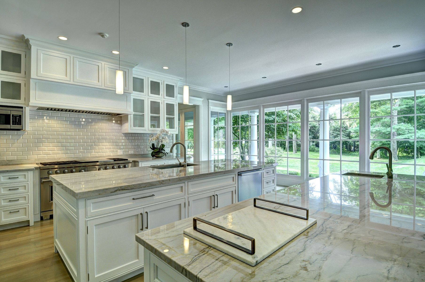 11 Jones Cove Road East Hampton, NY 11937 - Photo 6 of 25 a kitchen with a stove a sink a refrigerator and glass cabinets