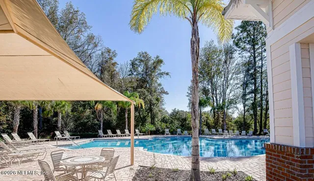 a view of a house with backyard and tree