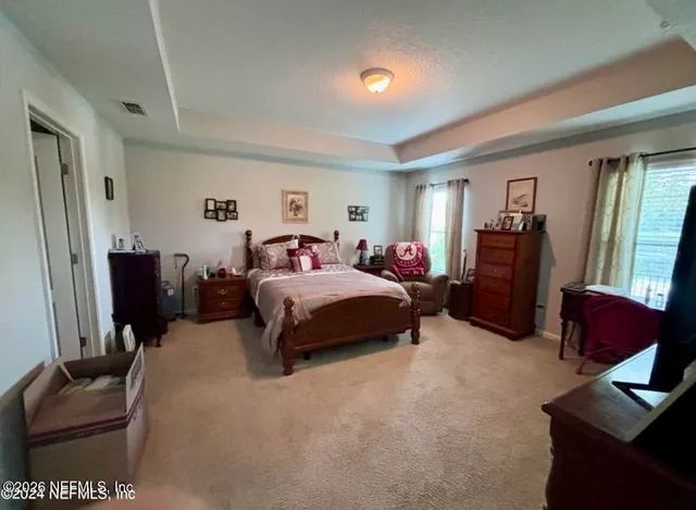 a bedroom with a bed and a couch