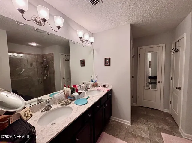 a bathroom with a sink vanity granite tub and shower