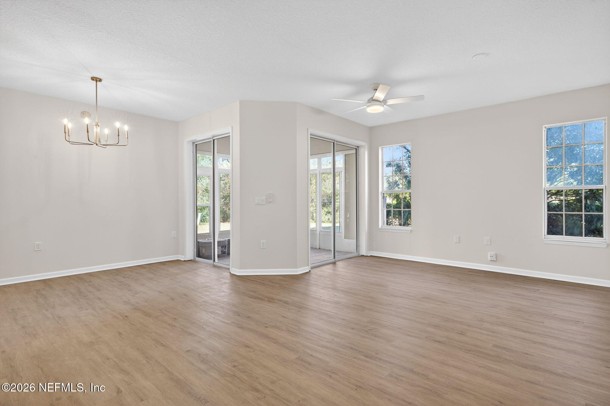 1610 Prestwick Place St. Augustine, FL 32086 - Photo 11 of 41 an empty room with wooden floor and windows