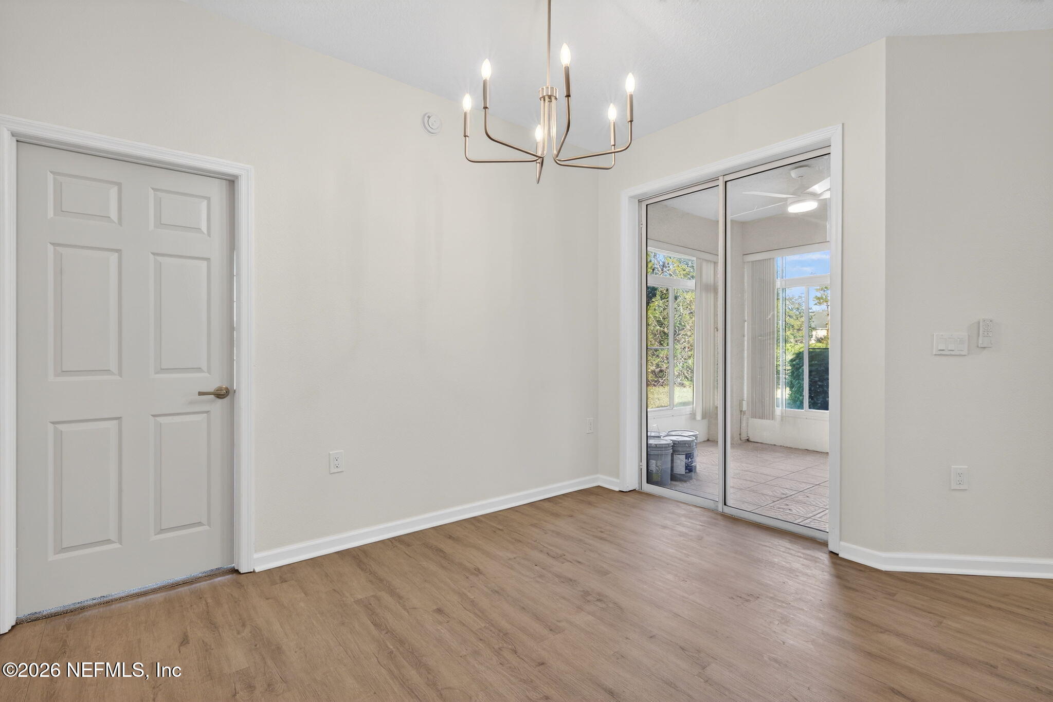 1610 Prestwick Place St. Augustine, FL 32086 - Photo 12 of 41 wooden floor in an empty room with a window
