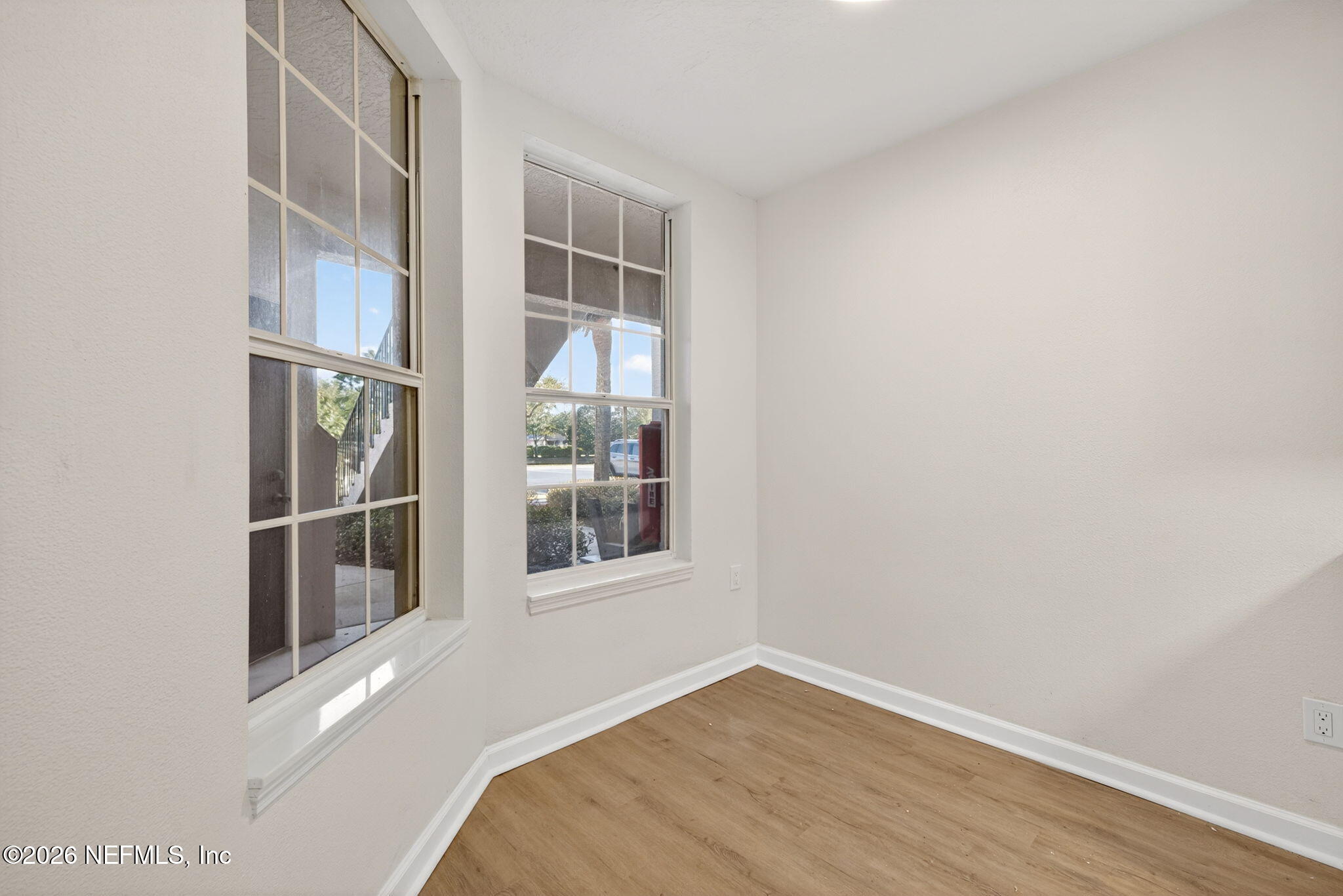 1610 Prestwick Place St. Augustine, FL 32086 - Photo 15 of 41 a view of an empty room with wooden floor and a window