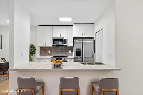 a kitchen with a sink cabinets and microwave
