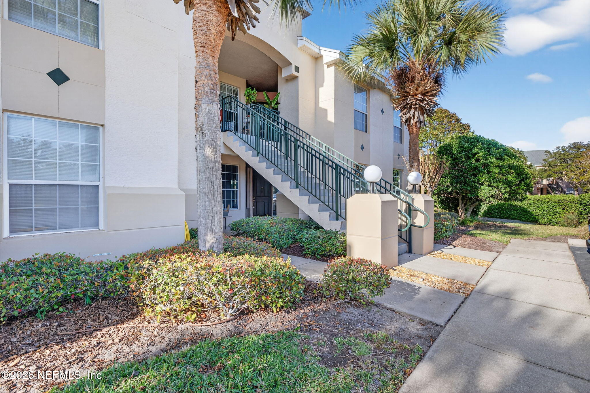 1610 Prestwick Place St. Augustine, FL 32086 - Photo 2 of 41 a front view of a house with a yard and potted plants