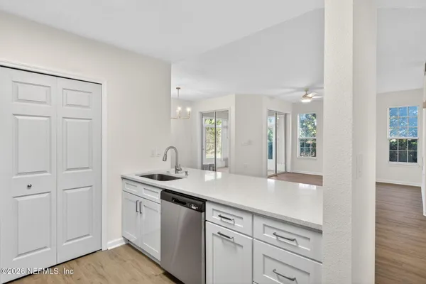 a kitchen with stainless steel appliances granite countertop a sink and dishwasher with wooden floor