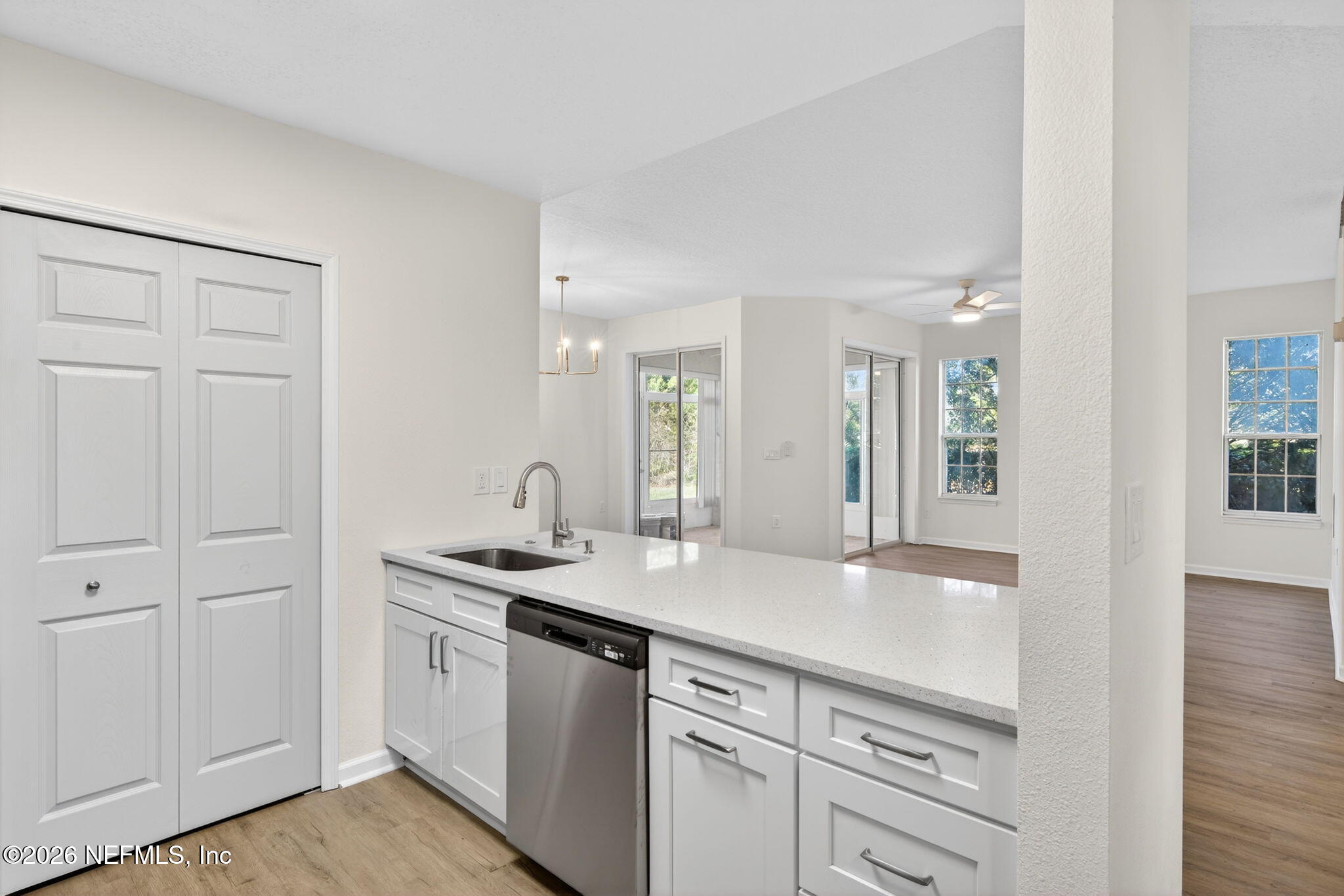 1610 Prestwick Place St. Augustine, FL 32086 - Photo 21 of 41 a kitchen with stainless steel appliances granite countertop a sink and dishwasher with wooden floor