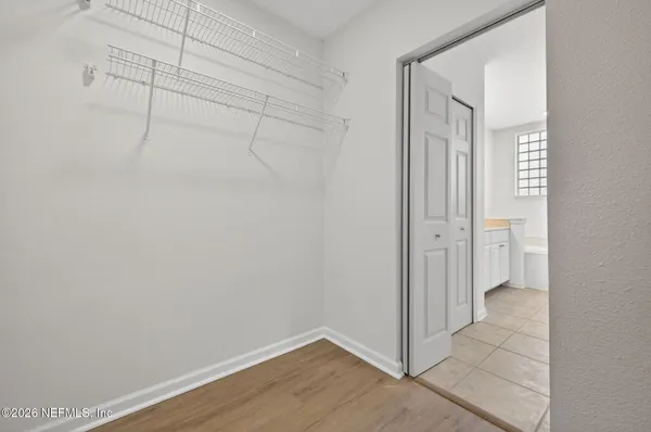 a view of a room with wooden floor
