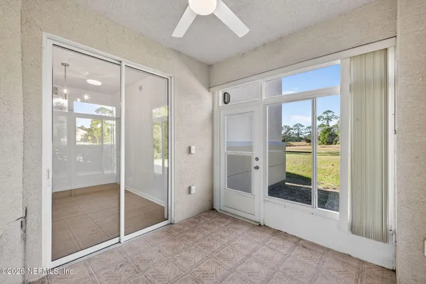 a view of entryway with bathroom and shower