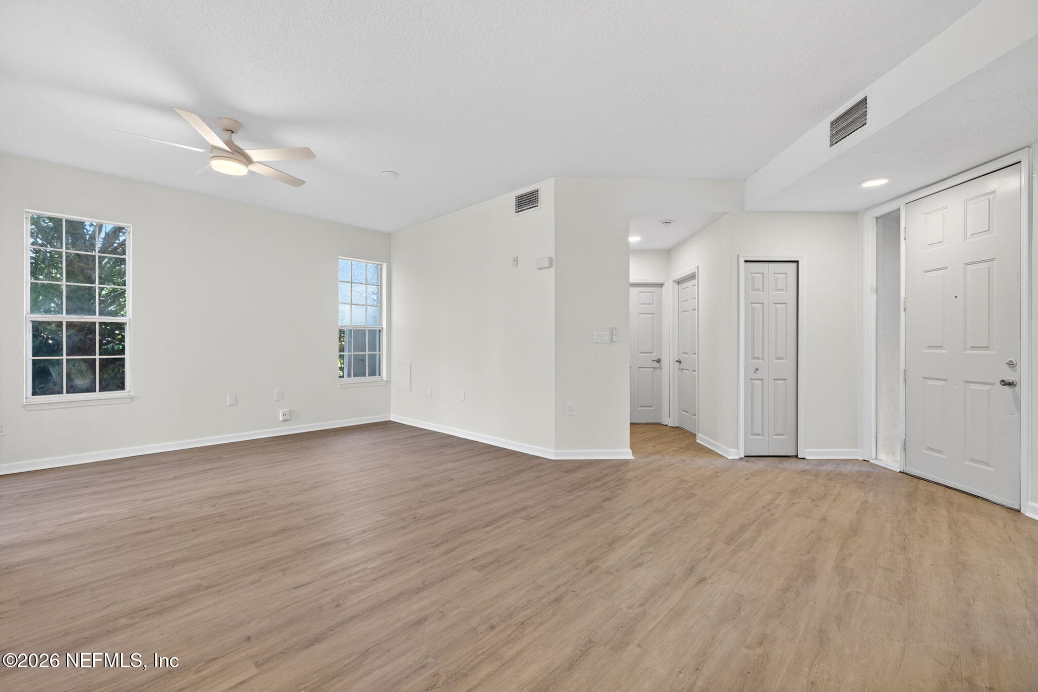 1610 Prestwick Place St. Augustine, FL 32086 - Photo 5 of 41 a view of an empty room with wooden floor and a window