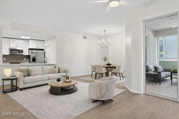 a living room with furniture and white walls