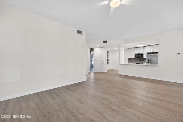 a view of kitchen with granite countertop cabinets and wooden floor