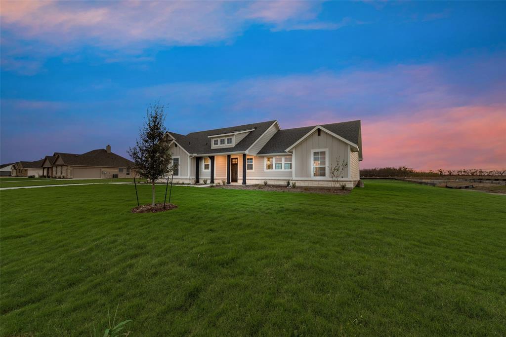 1230 County Road 200 Valley View, TX 76272 - Photo 7 of 26 View of front of house featuring a lawn, covered porch, and board and batten siding