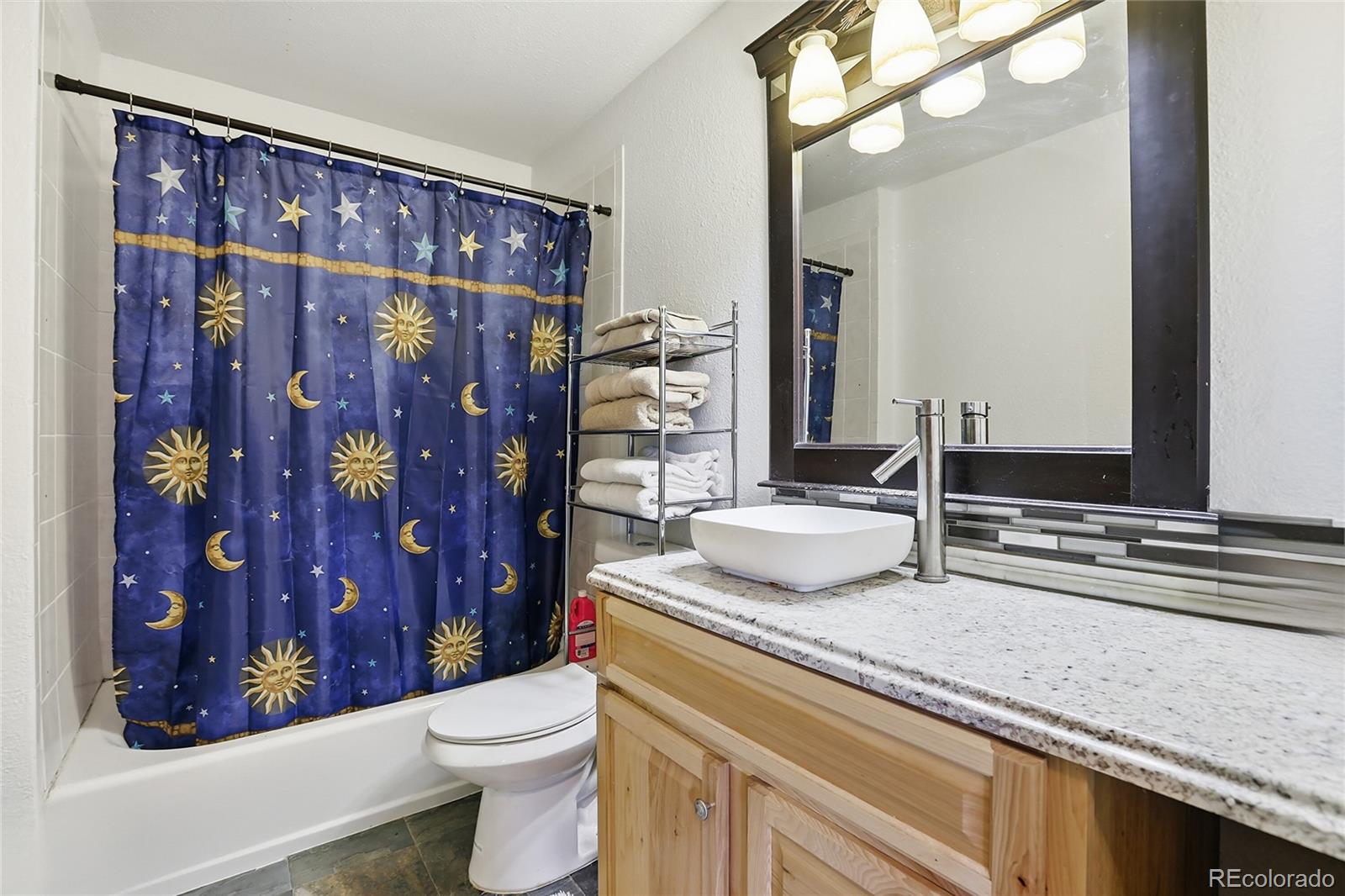 9225 Sandy Lane Conifer, CO 80433 - Photo 34 of 45 a bathroom with a granite countertop sink toilet and shower