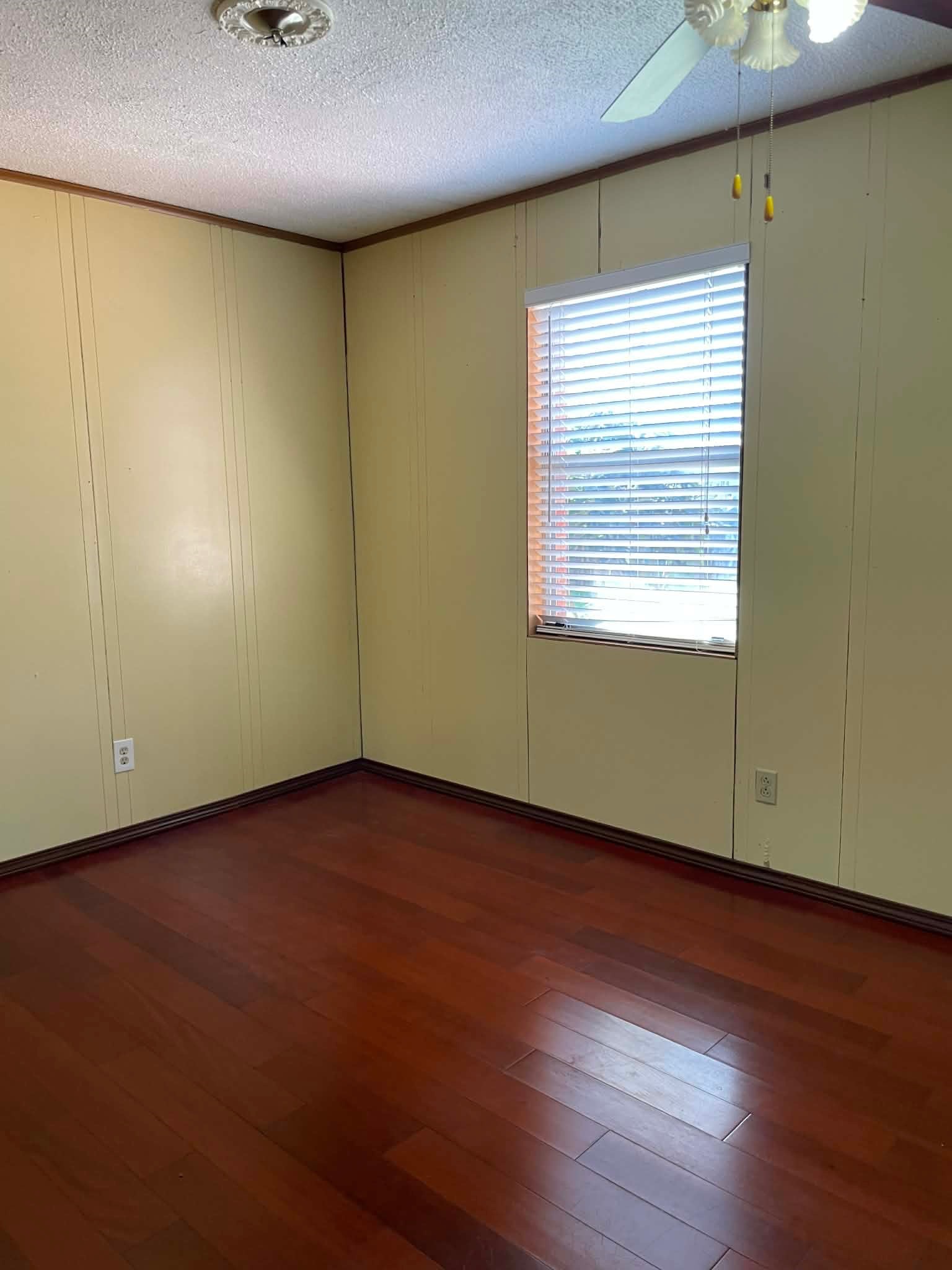 1825 Isom Street Houston, TX 77039 - Photo 25 of 27 an empty room with wooden floor and windows