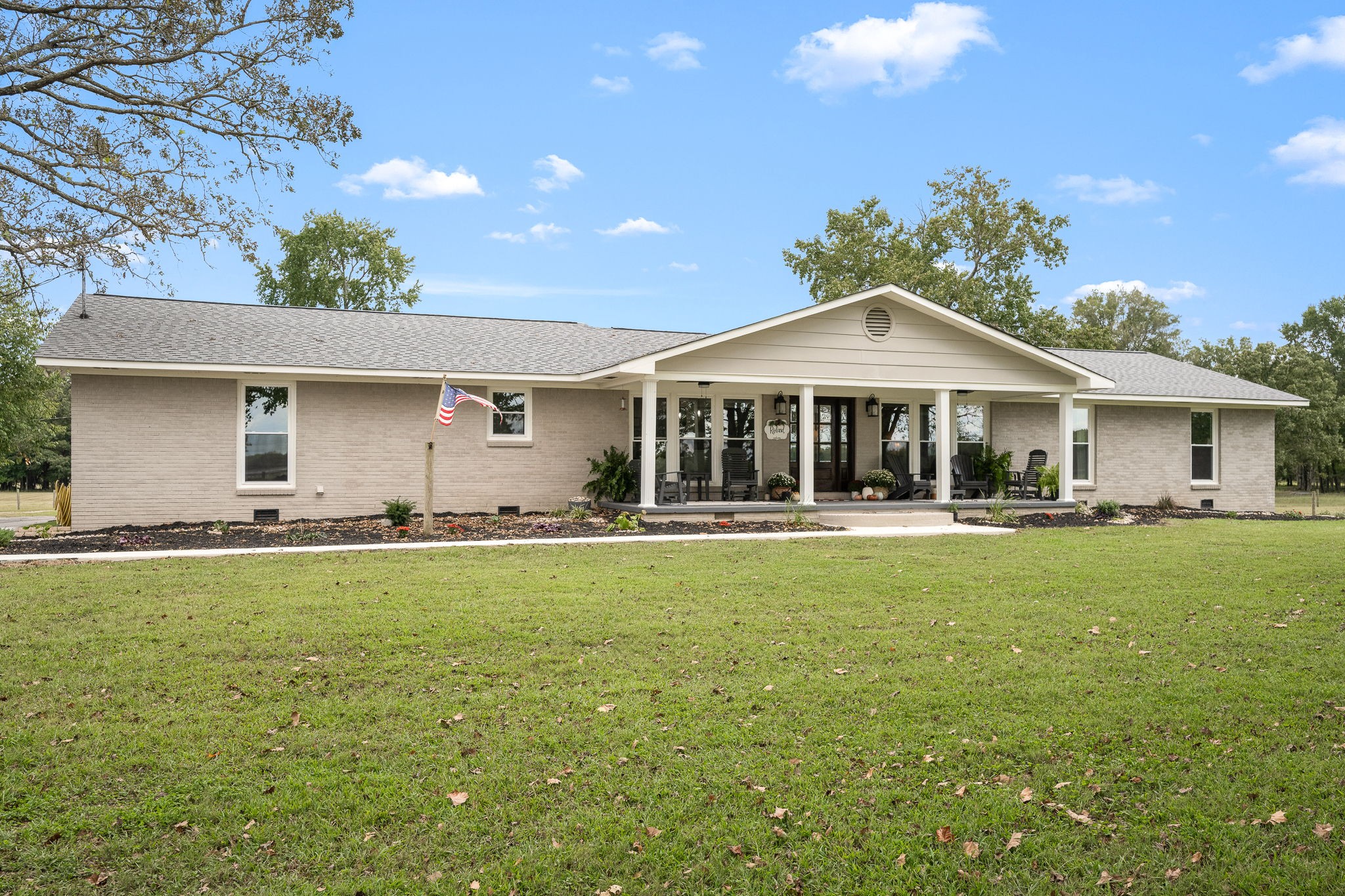 a front view of a house with swimming pool having outdoor seating