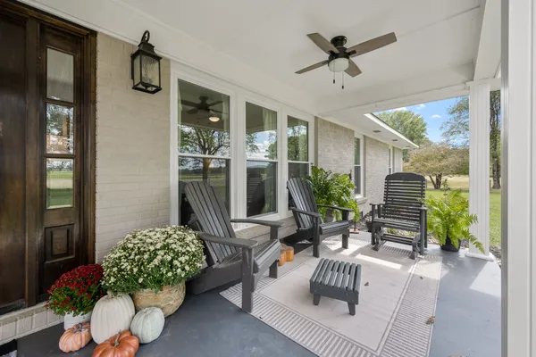 a front view of a house with swimming pool having outdoor seating