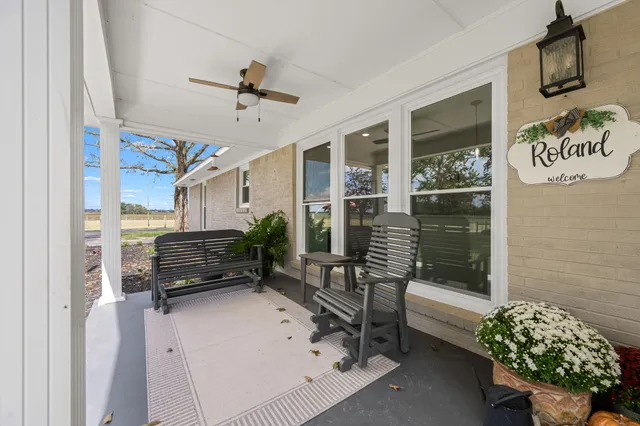 a living room with fireplace furniture and a wooden floor