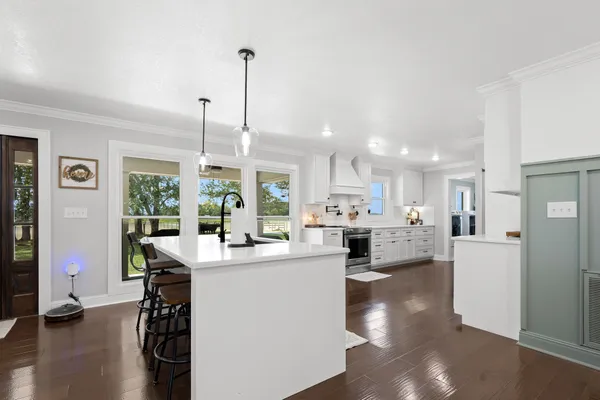 a bedroom with a bed and a lamp on dresser