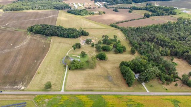an aerial view of a house with a yard and lake view