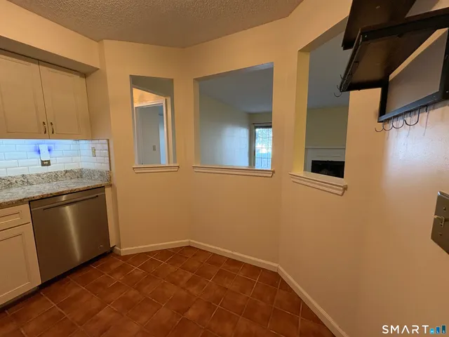 a view of a kitchen with a sink and dishwasher