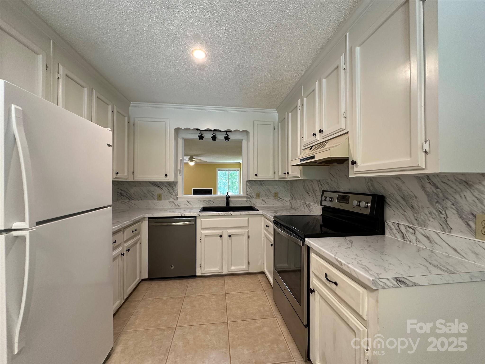 1590 Springpoint Road, Unit B Rock Hill, SC 29732 - Photo 14 of 39 a kitchen with granite countertop a refrigerator stove top oven and cabinets