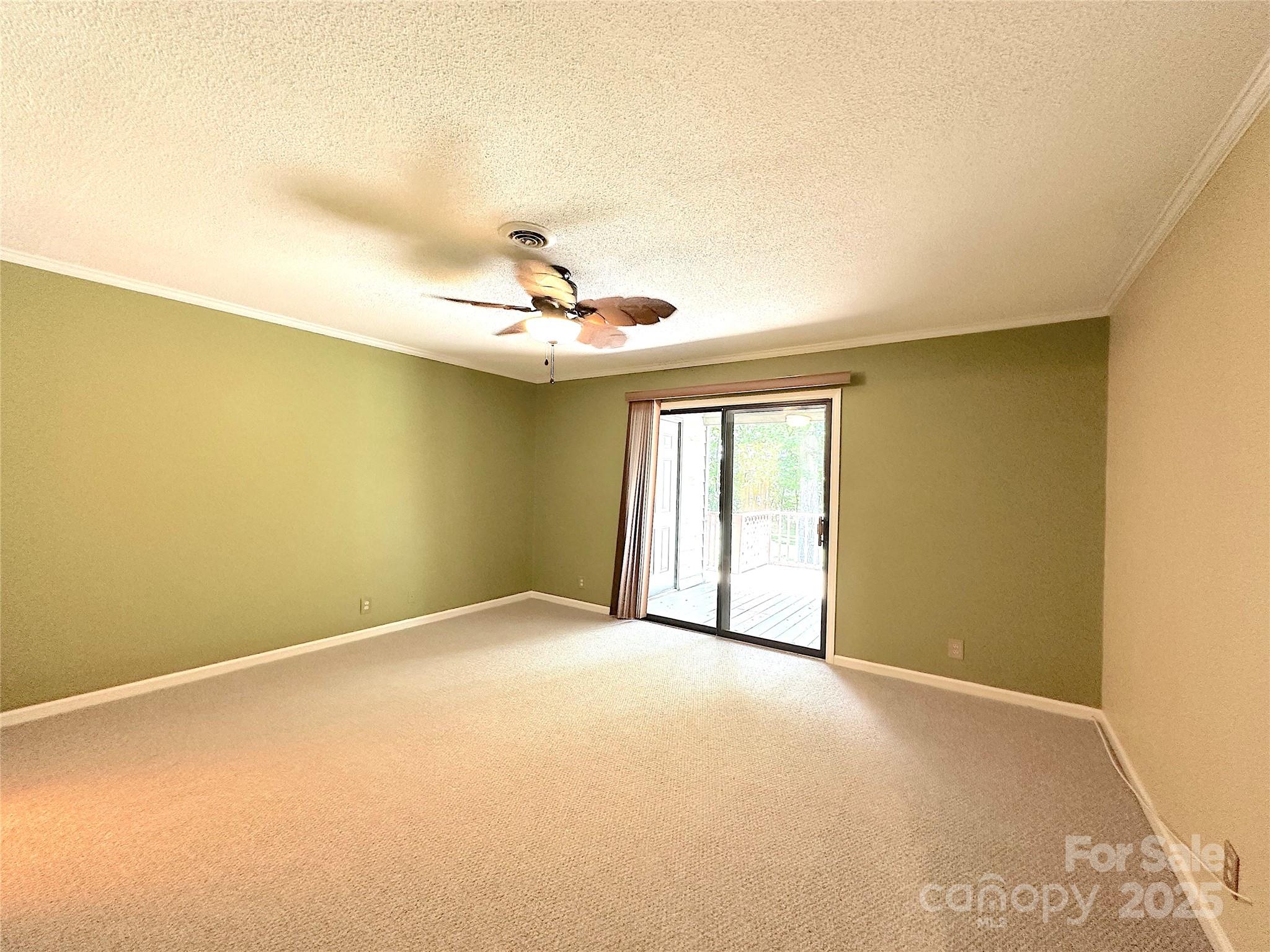 1590 Springpoint Road, Unit B Rock Hill, SC 29732 - Photo 27 of 39 an empty room with windows and chandelier fan