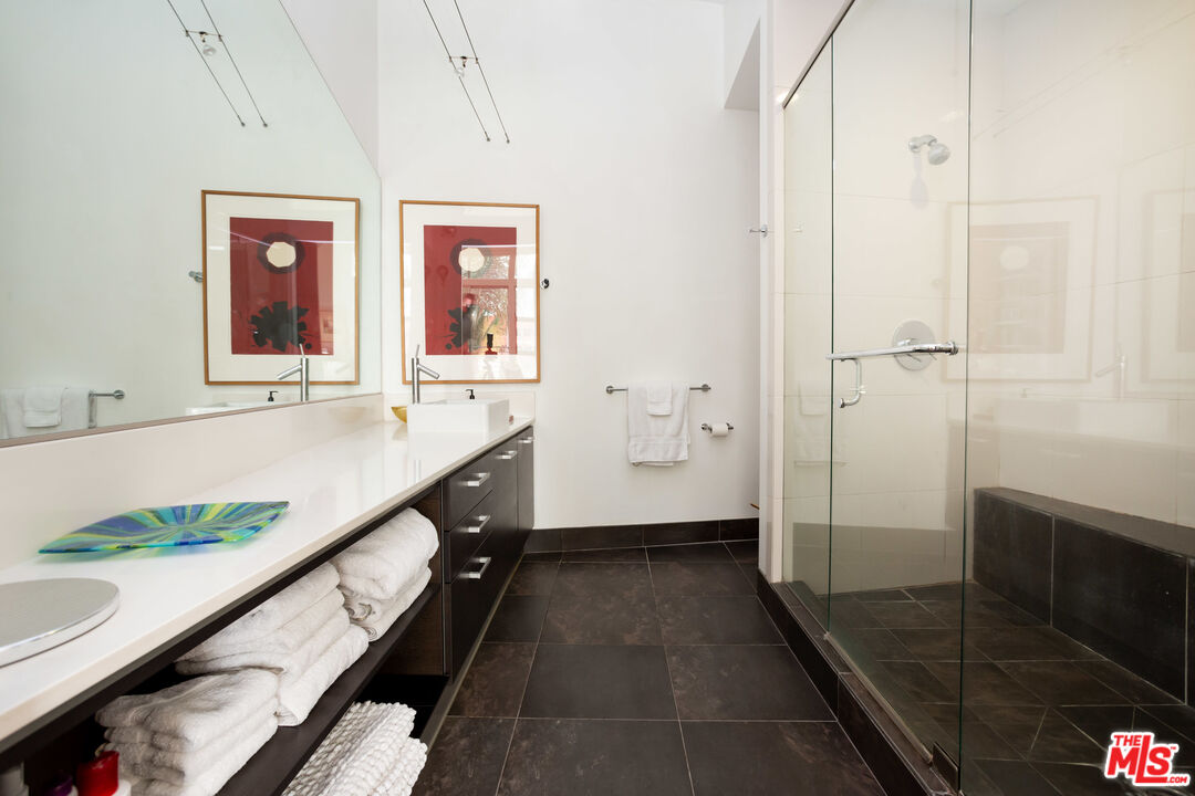 13320 Beach Avenue, Unit 304 Marina del Rey, CA 90292 - Photo 12 of 23 a bathroom with a granite countertop sink a toilet and shower