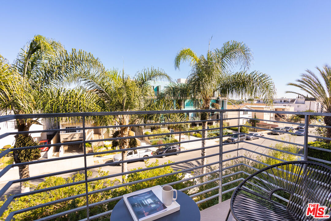 13320 Beach Avenue, Unit 304 Marina del Rey, CA 90292 - Photo 17 of 23 a view of a swimming pool with a chairs and table in the patio