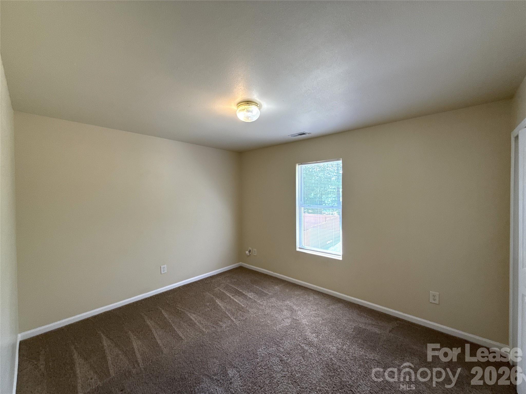 6831 Sunman Road Charlotte, NC 28216 - Photo 12 of 14 an empty room with a window
